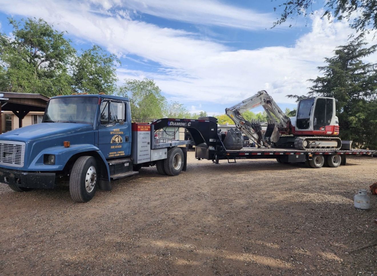 McGuire Septic & Excavation truck with Takeuchi excavator on a Diamond C trailer